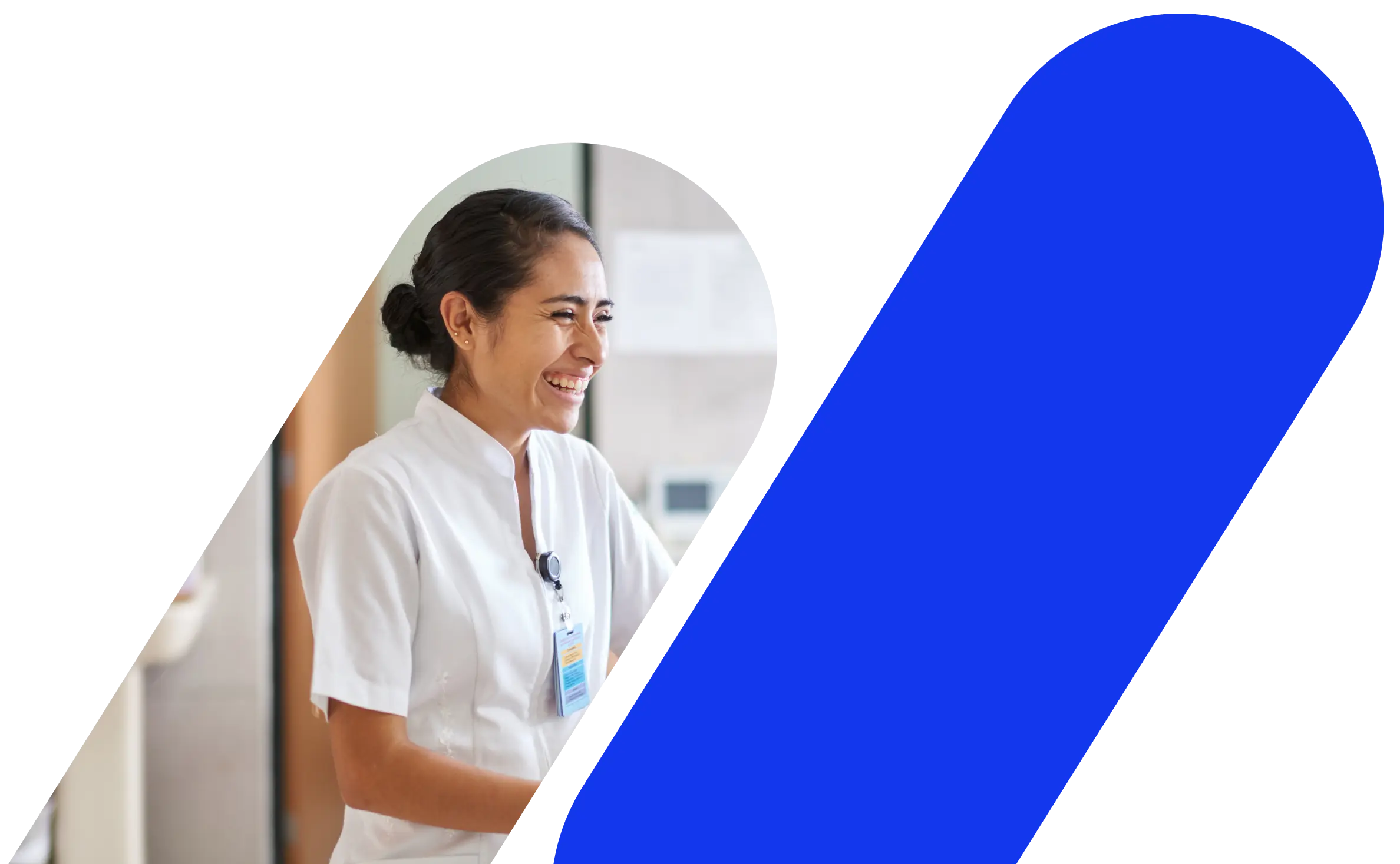 A woman smiling while working in a hospital.